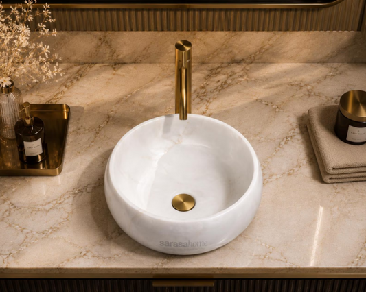 White marble round vessel sink with scalloped design