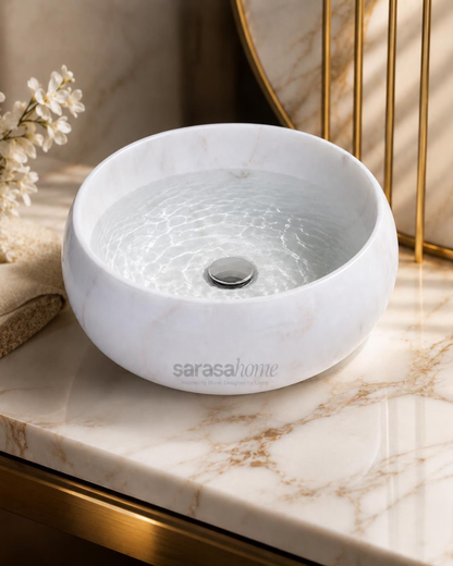 Scalloped white marble bathroom sink side view
